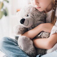 Mädchen umarmt Kuscheltier