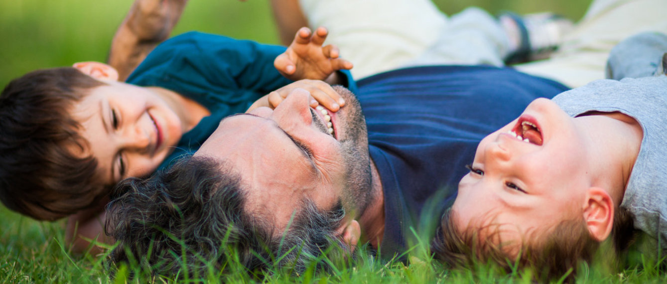 Kinder und Vater spielen im Garten