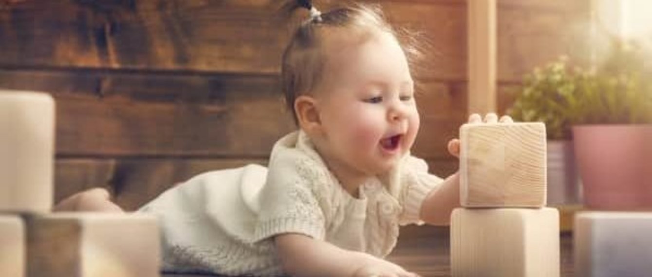 Baby spielt mit Holzwürfeln