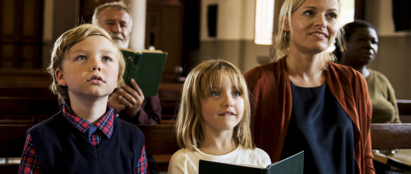 Mutter und Kinder in der Kirchenbank