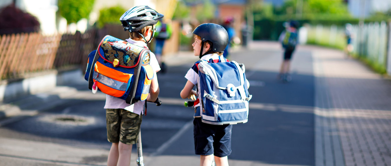 Zwei Schüler mit Schultaschen