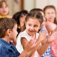 Kindergartenkinder klatschen in die Hände