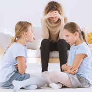Erschöpfte Mutter und streitende Kinder