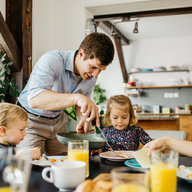 Familie isst gemeinsam Frühstück